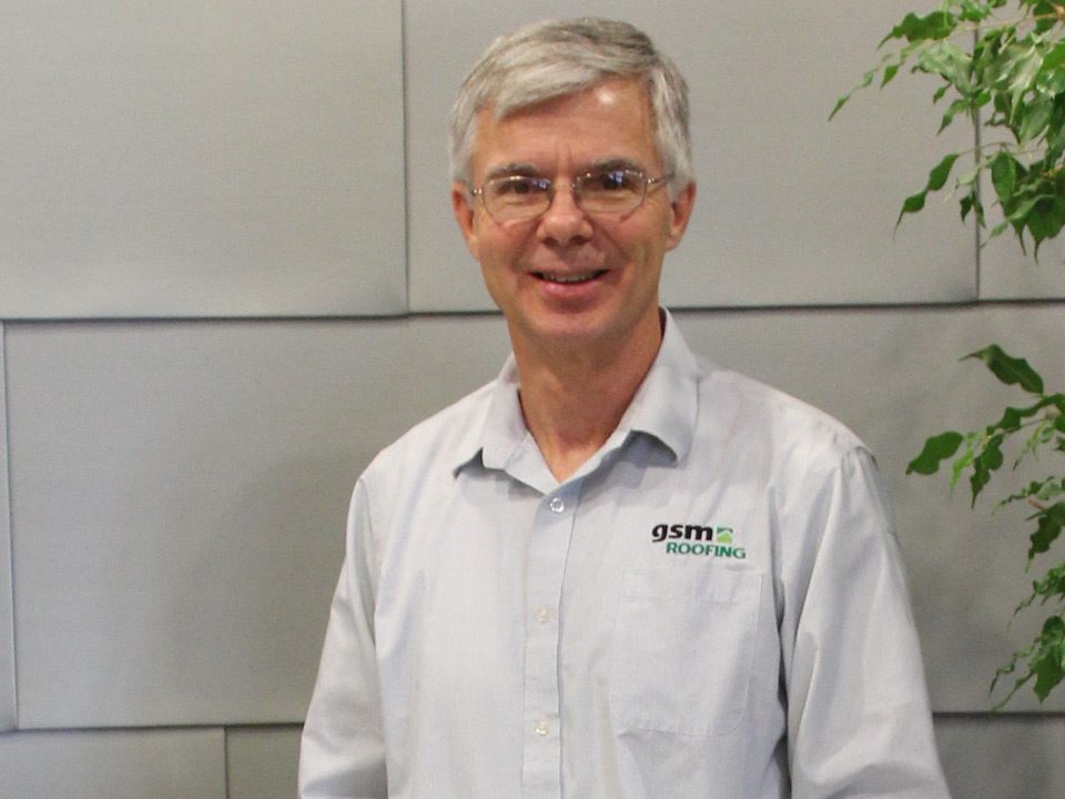Fred Kohler standing in GSM Roofing offices