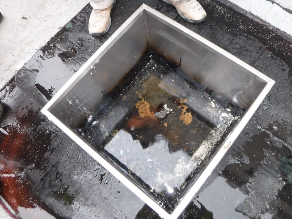 the 2x2 drain isolation chamber with 2-inches of water in it from hydrostatic water pressure from the 6th floor roofing drain lines
