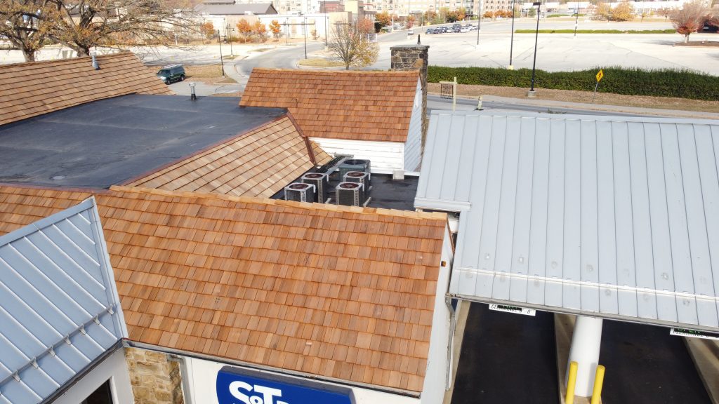 View of restored roof sections including new cedar shakes and updated EPDM around ventilation units