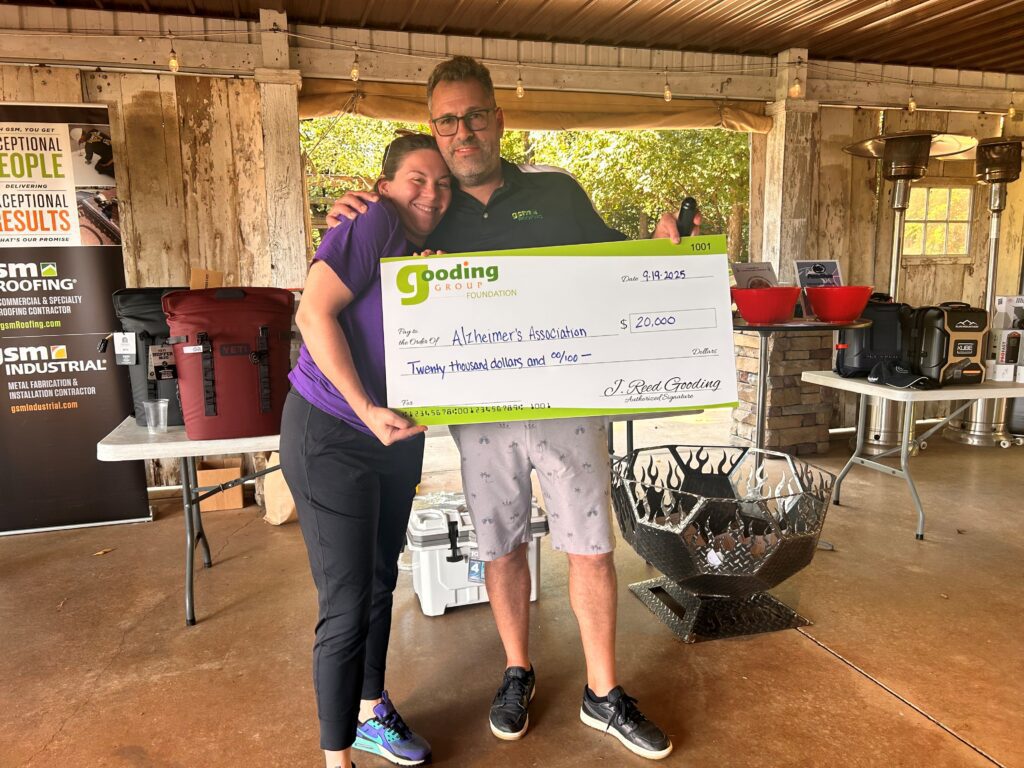 GSM Roofing presenting a ceremonial check to the Alzheimer’s Association, representing over $20,000 raised and matched by the Gooding Group Foundation