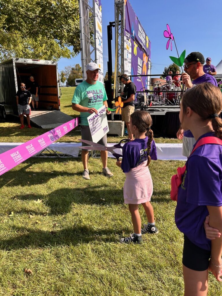 Madison Briggs getting ready to cut the ribbon to start the Walk to End Alzheimer's