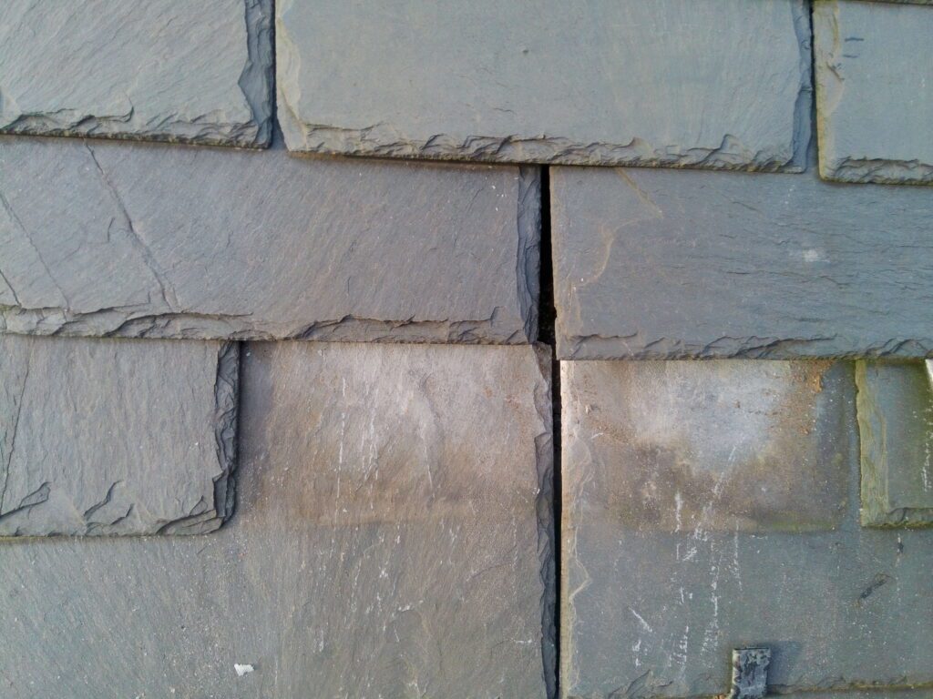 Missing head lap on Vermont Gray natural slate roof at historic National Register church in Tyrone PA Blair County showing insufficient course overlap and exposed joints documented by GSM Roofing 2024