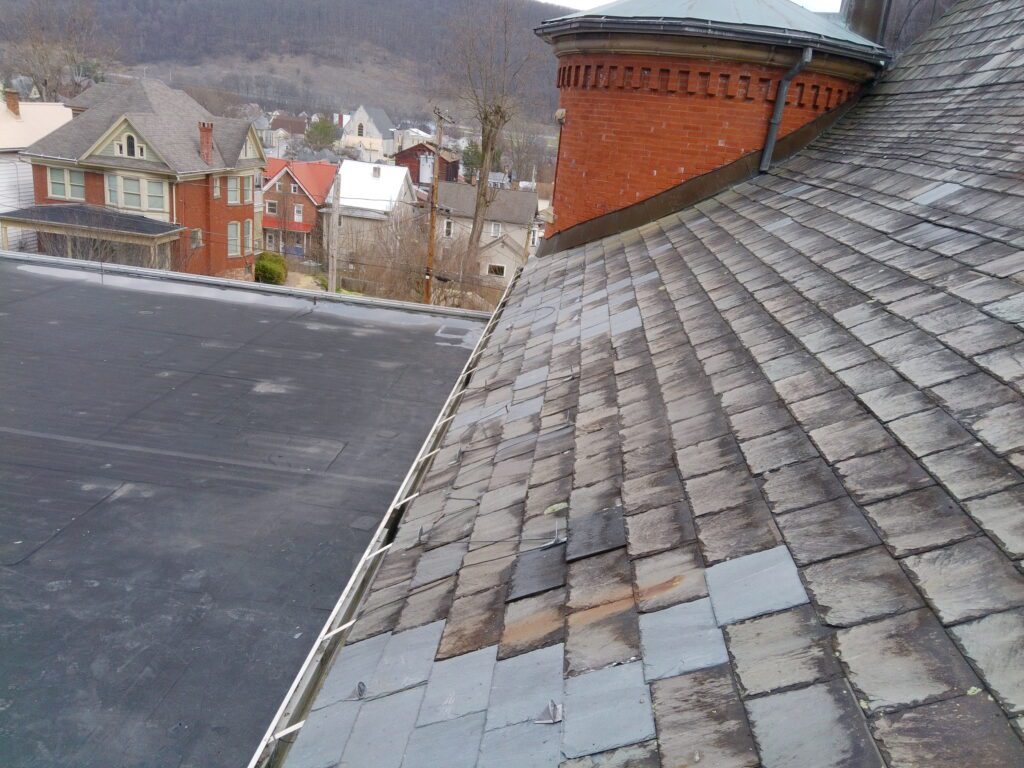 Vermont Gray slate roof field at St. Matthew Roman Catholic Church Tyrone PA Blair County showing fading and non-fading slate mix failed tiles and overall condition documented by GSM Roofing historic slate specialists 2024