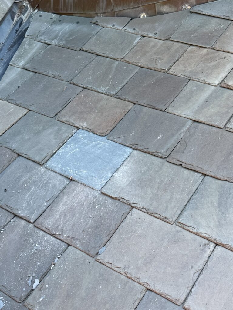 Close-up detail of completed Vermont Gray slate replacement tile set into historic church roof at St. Matthew Roman Catholic Church Tyrone PA by GSM Roofing Master Pro Certified Installer showing precise installation 2026