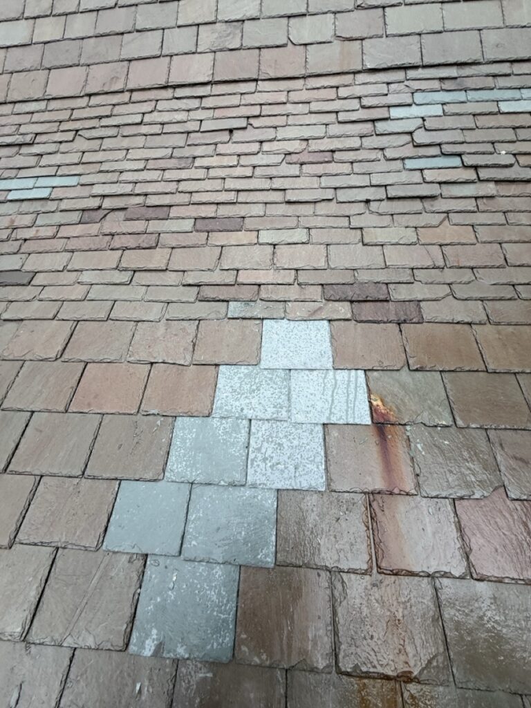 Completed slate repair at St. Matthew Roman Catholic Church Tyrone PA showing new Vermont Gray replacement tiles set into existing fading slate field by GSM Roofing Master Pro Certified Installer 2026